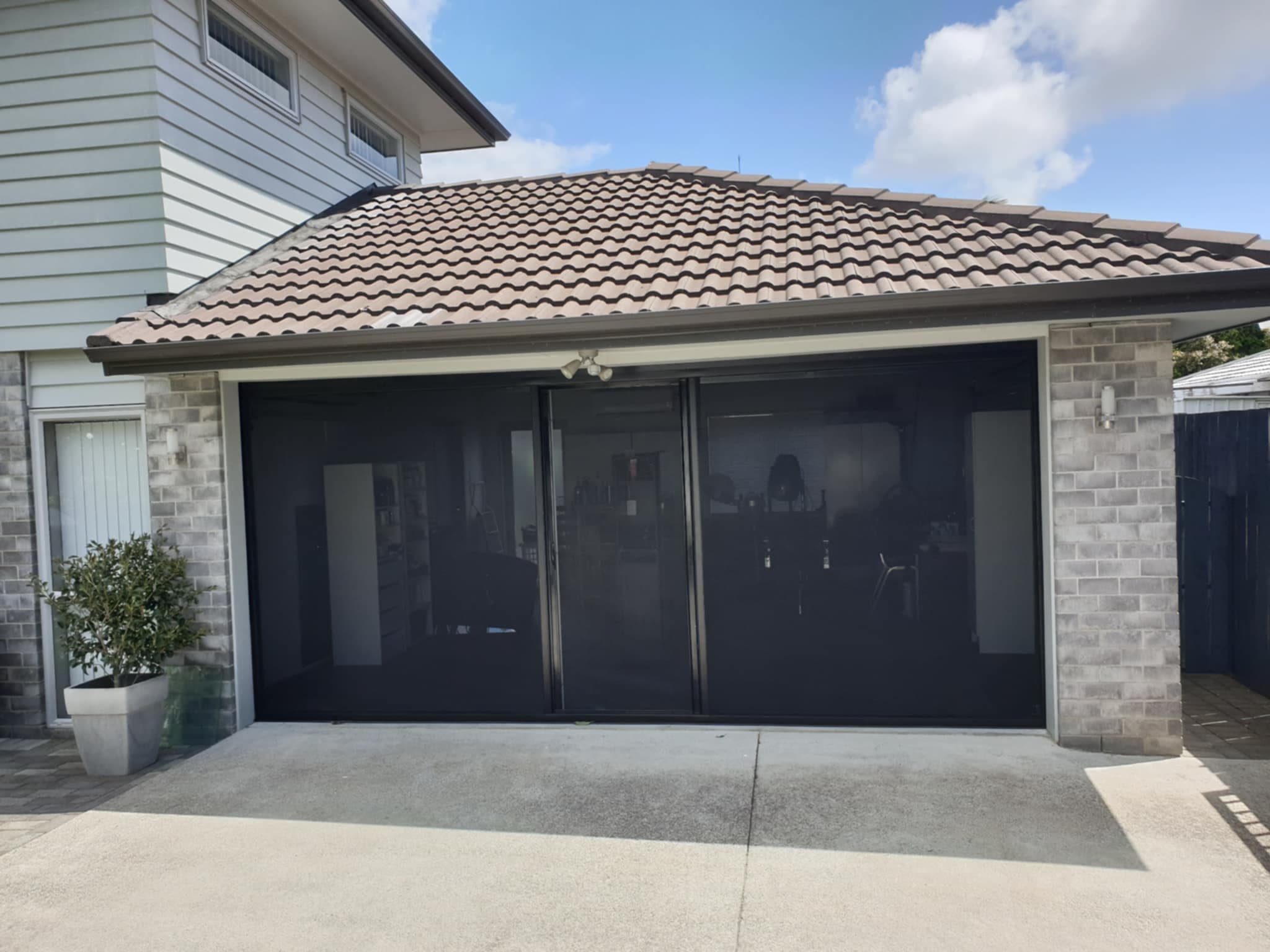 Stone Facade Garage with Black Screen System